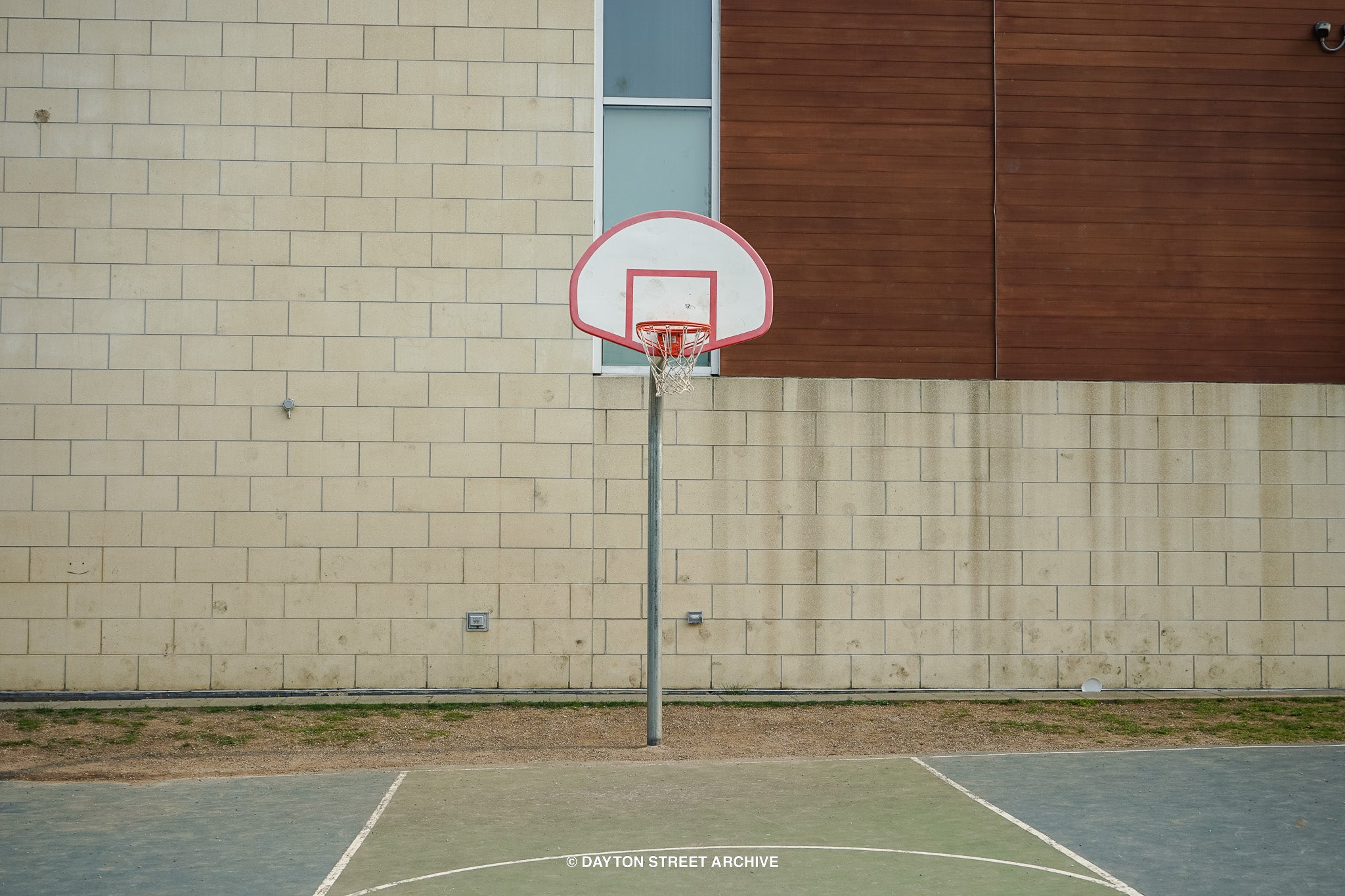 vintage basketball hoop in schoolyard court with abstract modern background