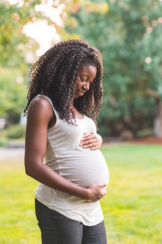 Pregnant woman holding belly