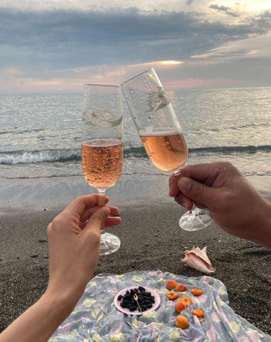 Clinking wine glasses on the beach