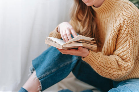 A woman sitting in comfortable shoes and relaxed outfit