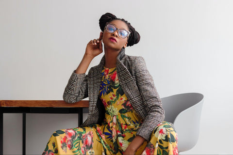 Young woman in colorful, floral dress