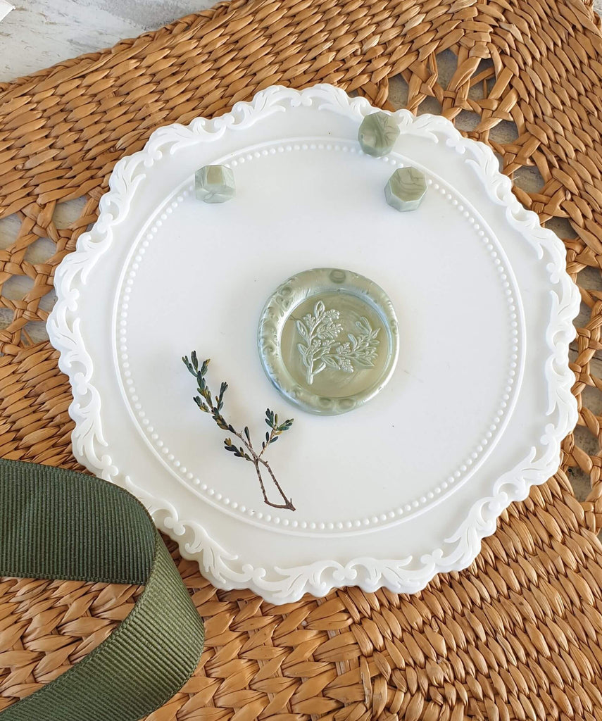 sage green wax seal with foliage design