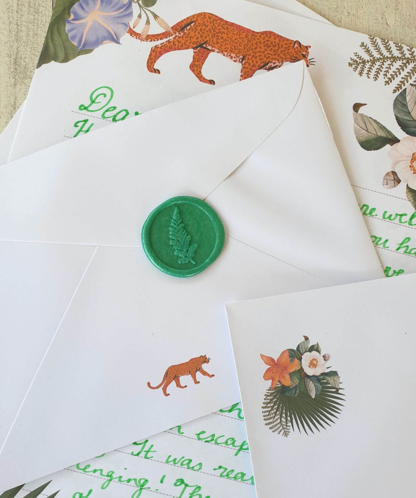 Letter and envelope with handwritten calligraphy and green leaf wax seal