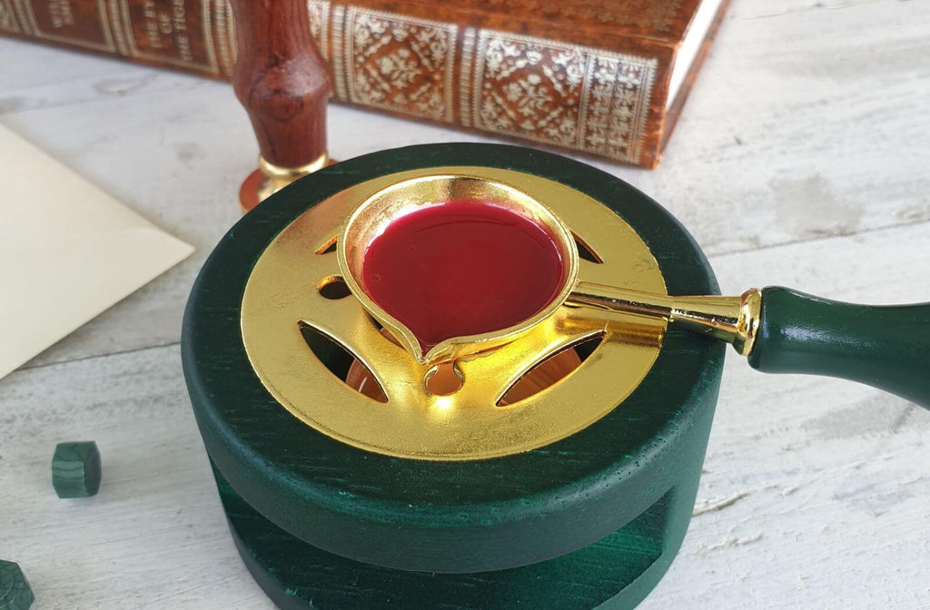 red sealing wax being melted in wax melting stove