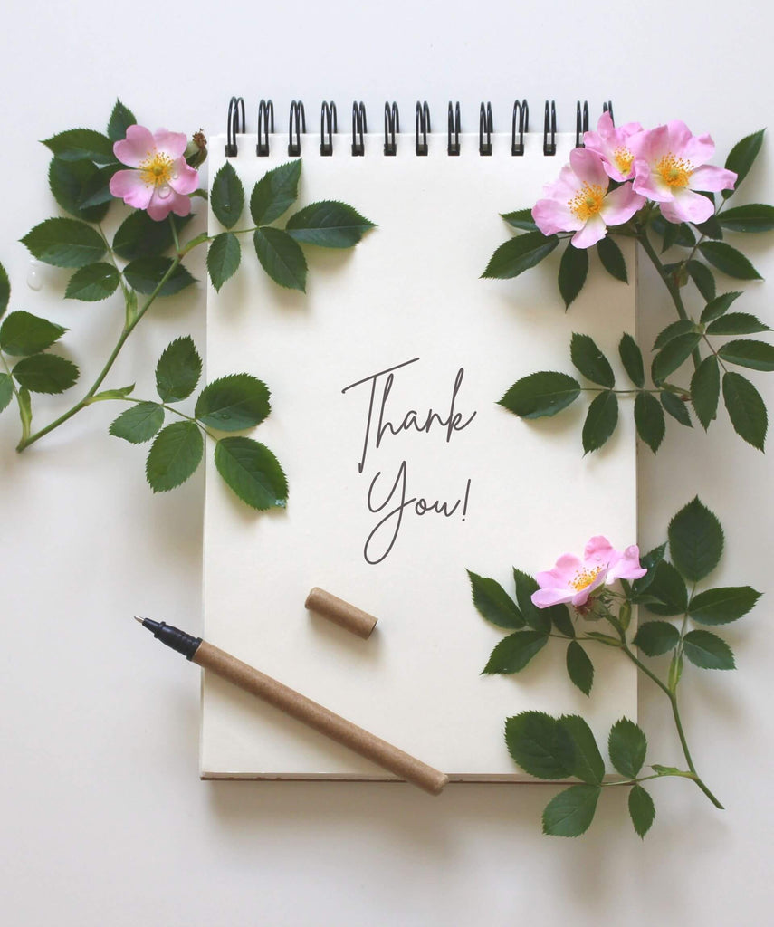 letter writing pad with pink flowers and pen and thank you note