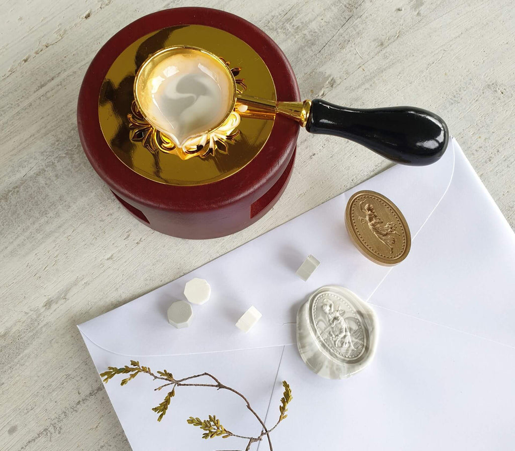 Goddess wax seal in grey and white marble wax with white envelope, dried flowers and sealing wax granules