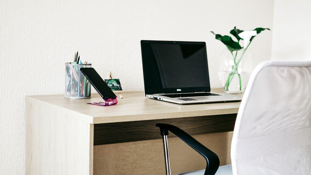 white minimalist desk setup with laptop