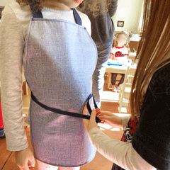 Children tying each others aprons