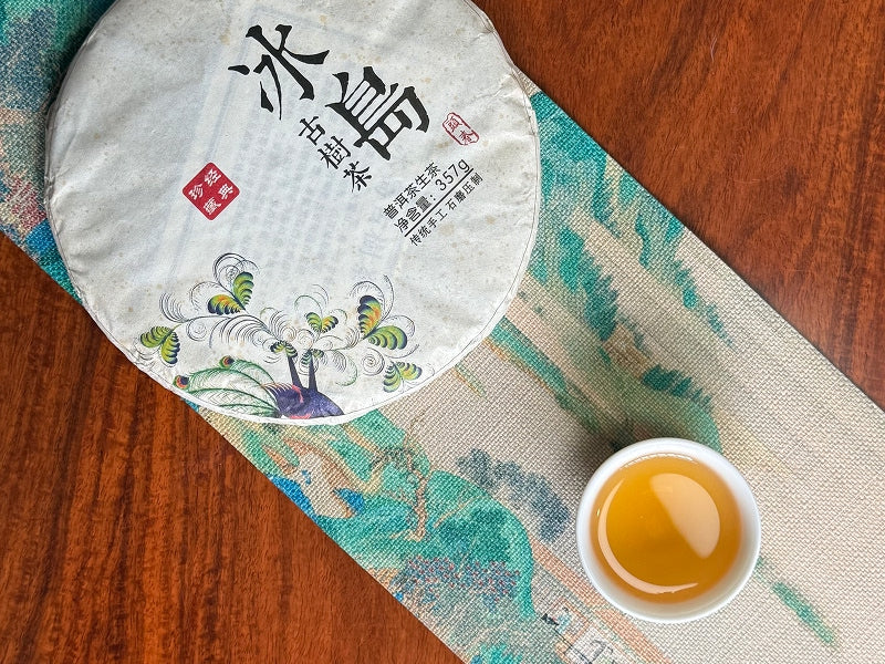 Pu-erh tea cake and brewed tea, showcasing Chinese Tea Group quality