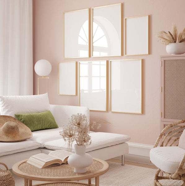 blush colored living room with white sofa and modern gallery wall