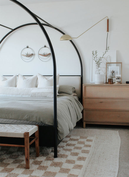 modern bedroom with braid & wood plant hangers in black and walnut styled above bed