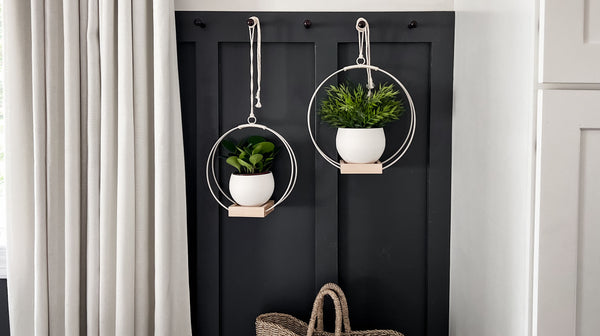 two braid & wood hanging platers styled with white pots in entryway