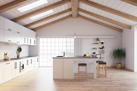 Kitchen with an island and wooden beams on the ceiling. The beams and the hardwood floor have a nice contrast between the two wood tones. Display how to successfully mix wood tones.