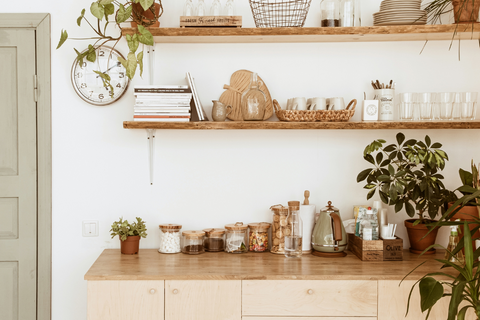 Open shelves in a kitchen with a nice selection of wooden accessories.