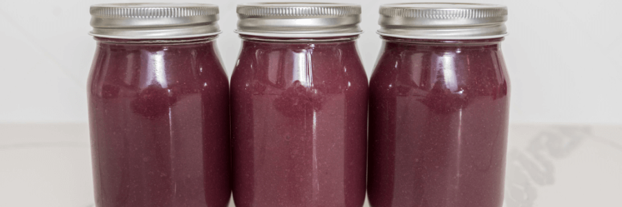 Three large mason jars filled with purple sea moss gel
