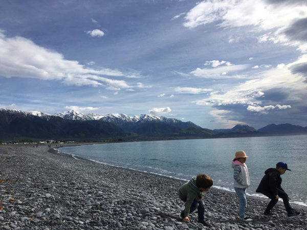 Three children on a New Zealand beach