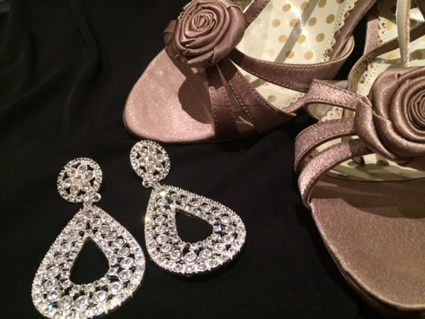 Image of sparkly earings and evening shoes