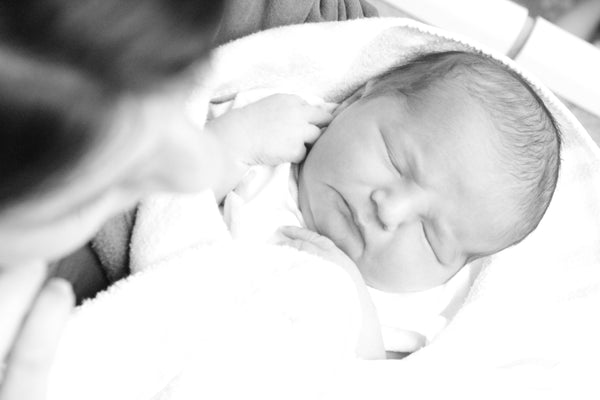 Black and white image of a baby asleep