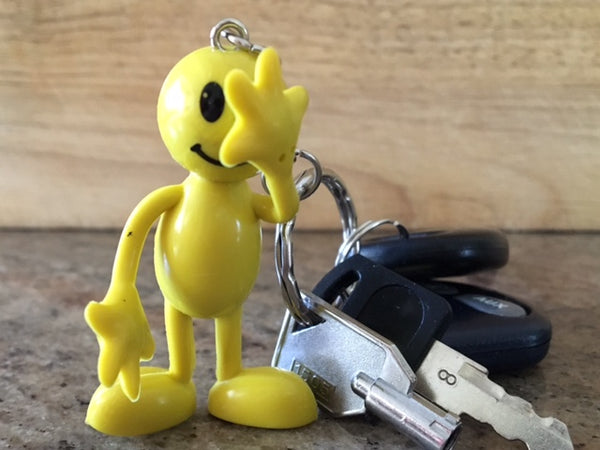 Image of a yellow person figurine attached to a set of keys