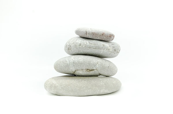 Image of stones stacked on top of one another against a white background