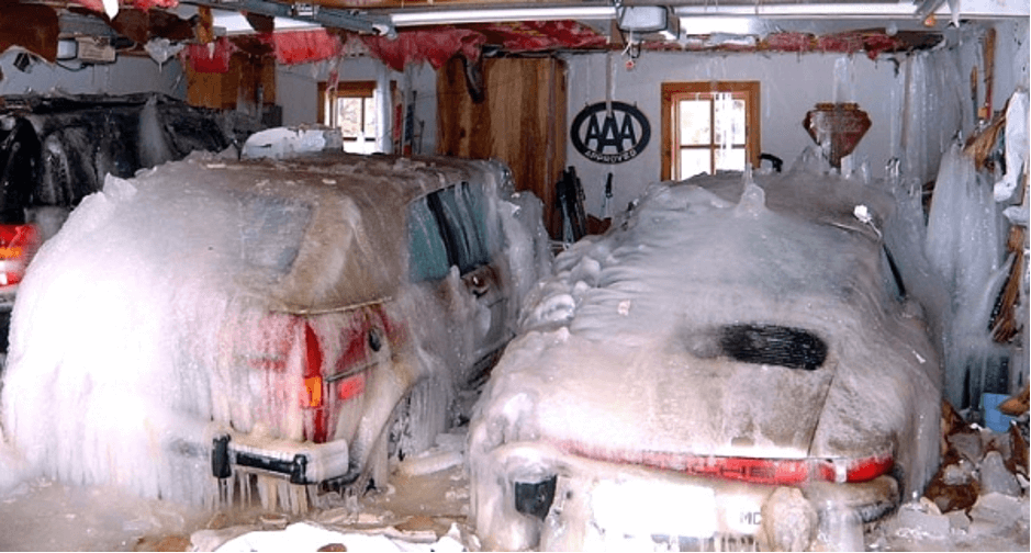 cars in a garge frozen with a solid sheet of ice