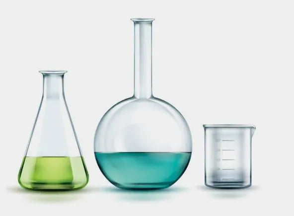 Glass Beakers with Chemicals in them, and a measuring low form beaker next to them.