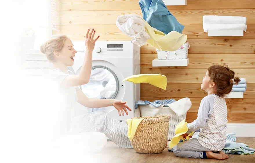 Mom and Daughter playing and doing the laundry