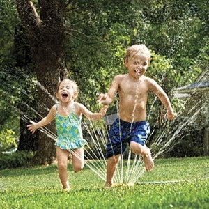 Kids Running Through the Sprinkler Outside