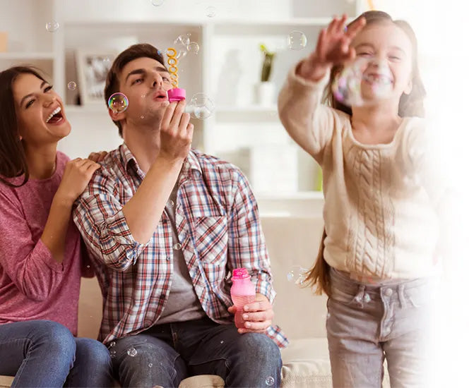 Family spending time together playing with bubbles