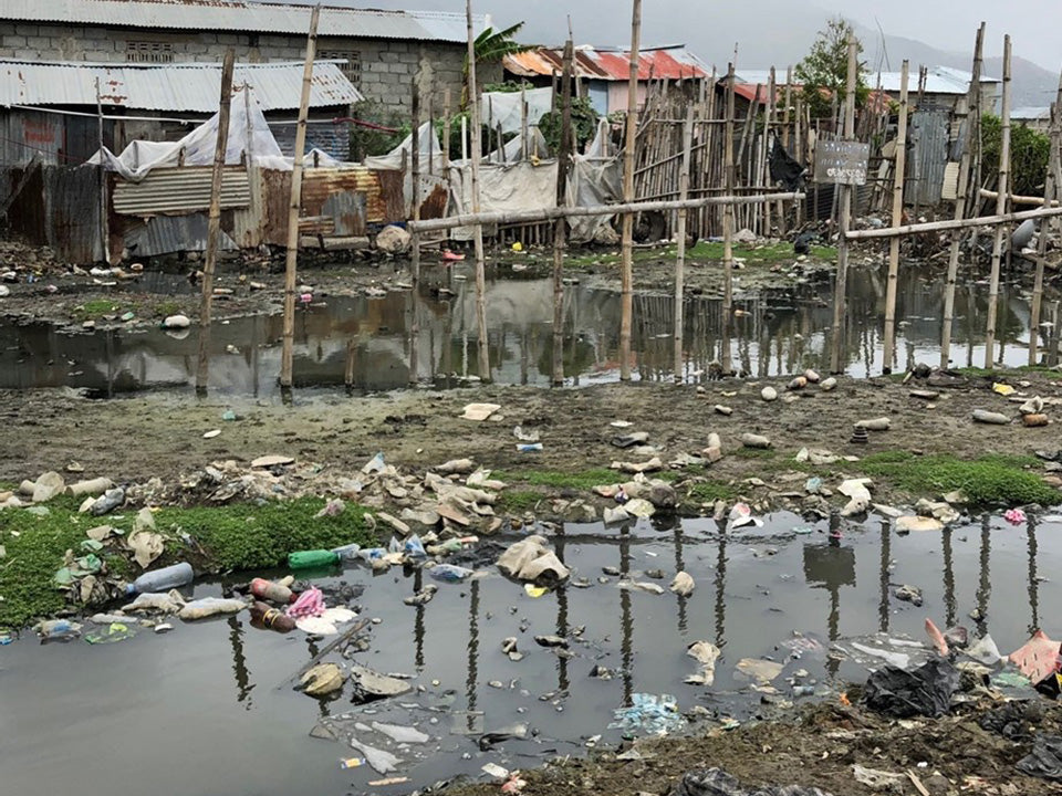 Garbage / Waste Dump around make shift housing & trash dumped in water