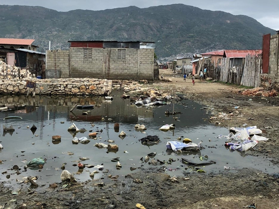 Garbage / Waste Dump around make shift housing & trash dumped in water