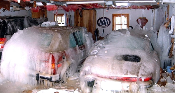 Cars in a garage covered in ice from a water leak