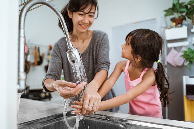 Mother and Daughter washing their hands together