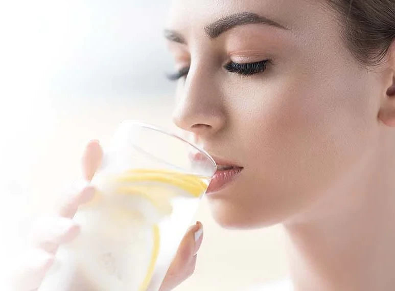 Woman drinking lemonade on a hot summer day