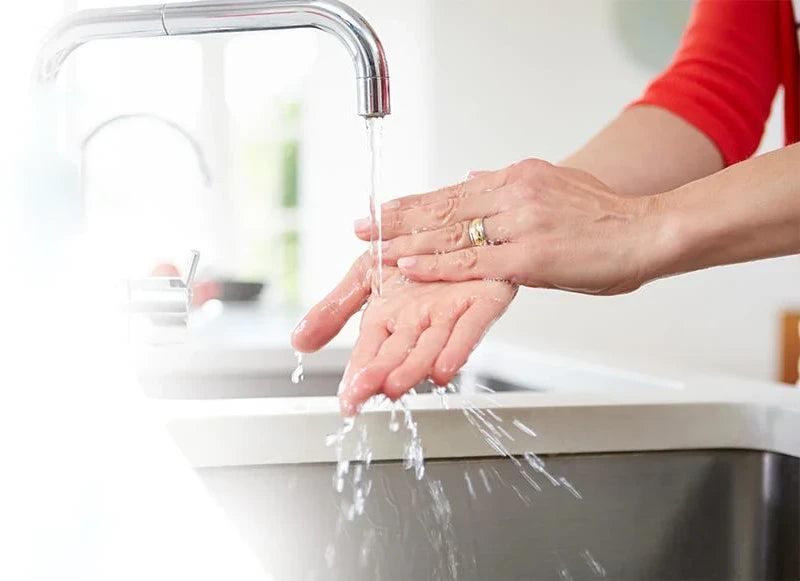 Woman rinsing her hands in the sink