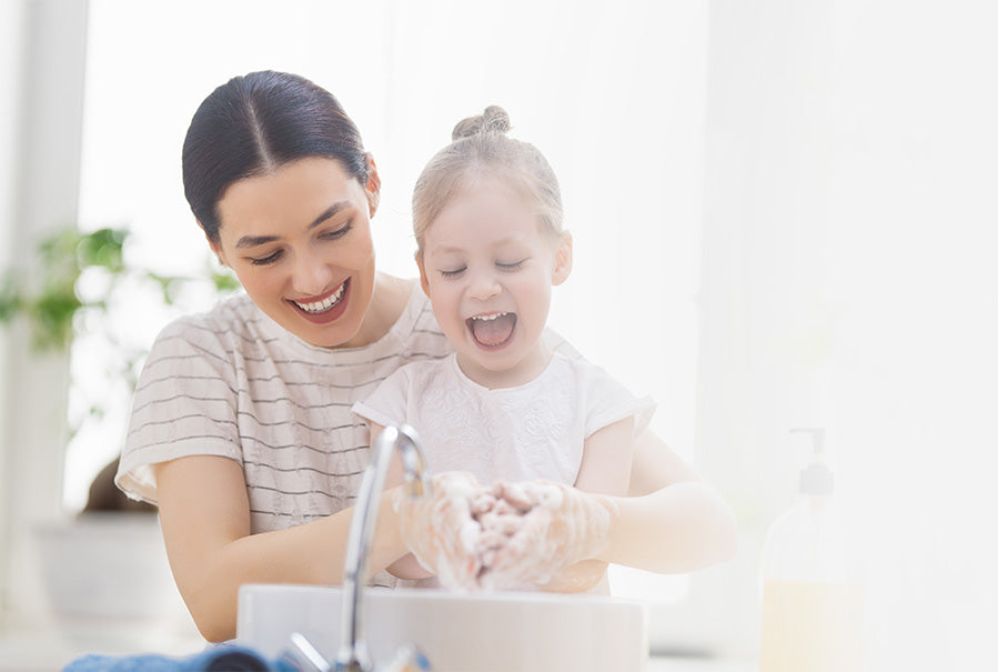 Woman Washing Child's Hands in Soft Filtered Water