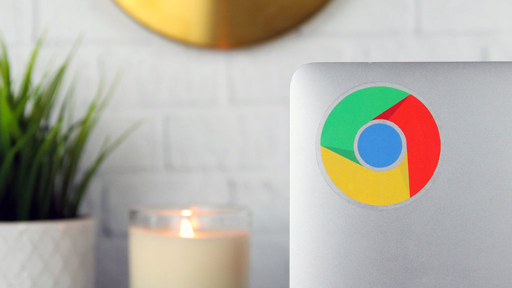 Circle clear sticker with Google Chrome design applied to a silver laptop