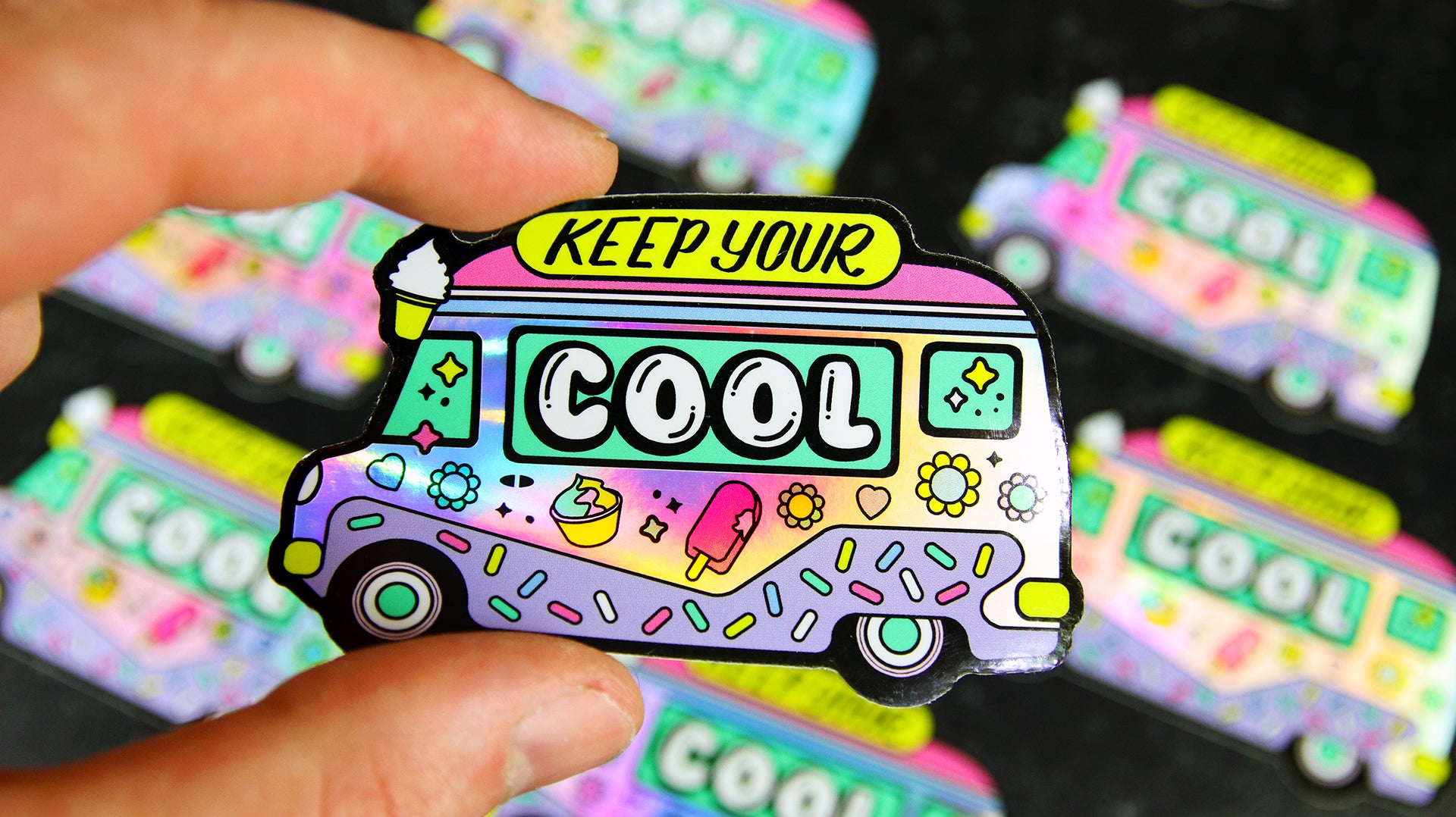 Die cut holographic sticker with old school ice cream van design hand held