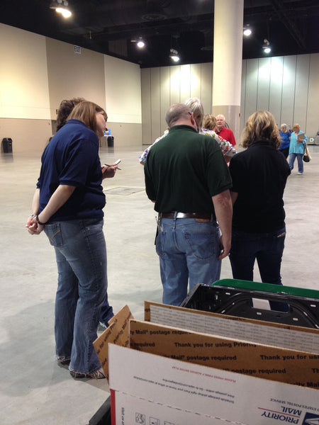 Producers, crew members, a police officer and Colleen Fresco huddled around the notebooks