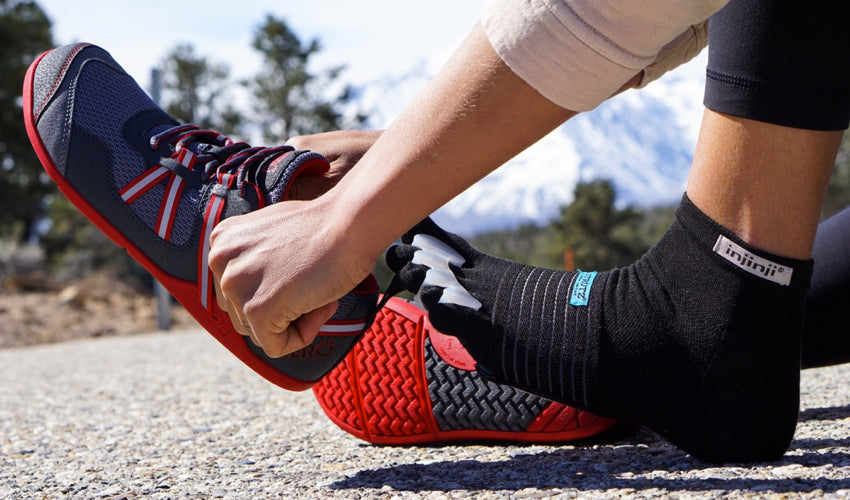 Runner pairing foot-healthy Xero Prio athletic shoes with Correct Toes toe spacers, Injinji toe socks, and Strutz foot pads