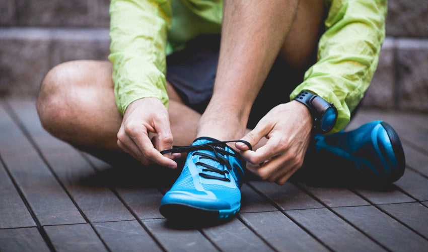 Runner putting on tapering toe box minimalist shoes