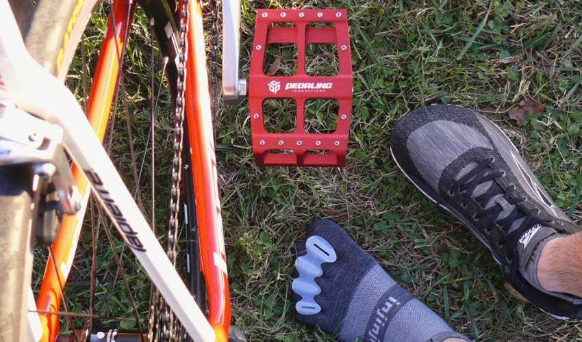 Top-down view of Catalyst Pedals, Correct Toes toe spacers, Injinji toe socks, and foot-shaped athletic shoes