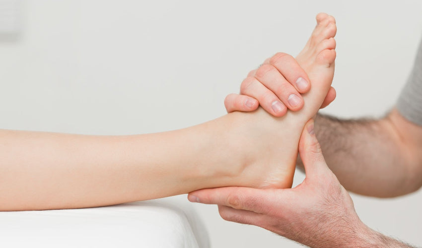 A chiropractor performing an adjustment on a patient's foot