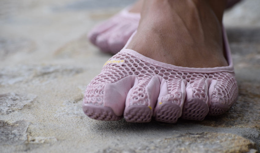 A close-up view of the breathable mesh upper of a pair of Vibram FiveFingers VI-B toe shoes