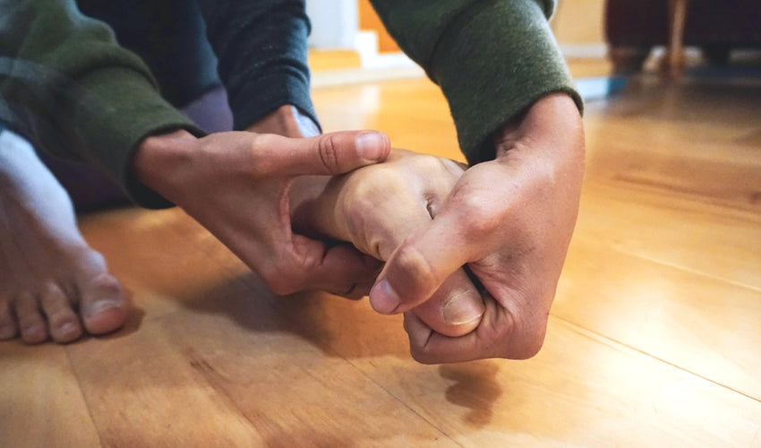 A person performing the Toe Extensor Stretch on themselves