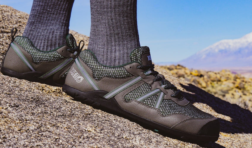 Trail runner wearing Xero TerraFlex Forest athletic shoes poised to begin a run