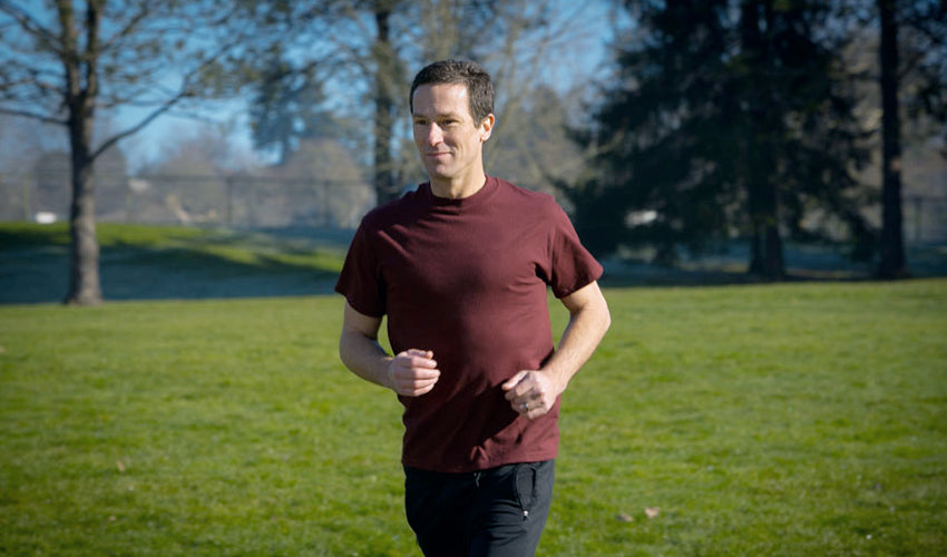 Correct Toes inventor Dr. Ray McClanahan jogging through a park in Portland, OR