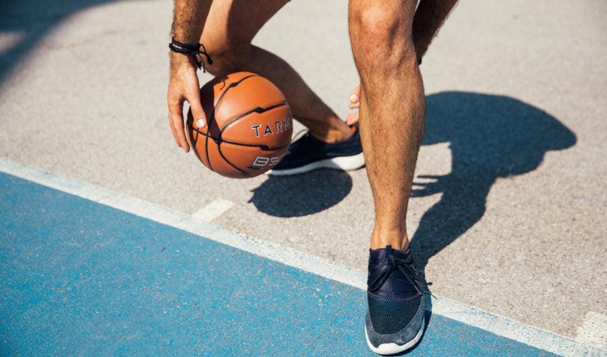 A basketball player dribbling a ball