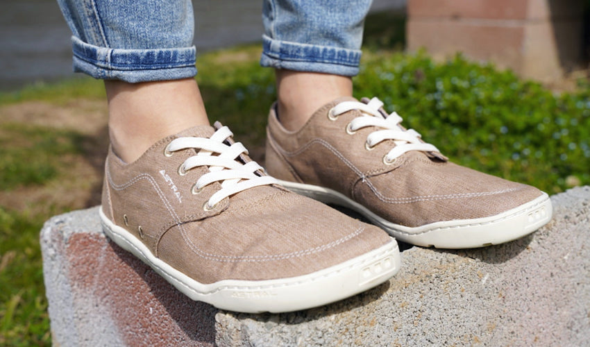 Close-up shot of a pair of Astral Hemp Loyak shoes with a river in the background