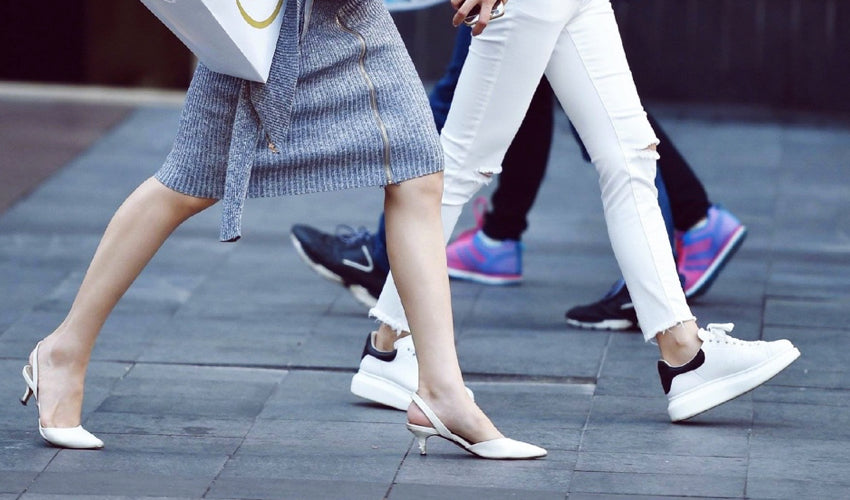 Two women in shoes with heel elevation walking side by side